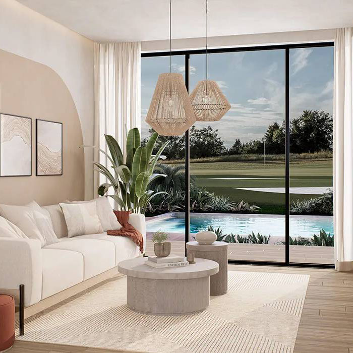 Apartments in Cana Bay, Punta Cana. Living room overlooking the pool and golf course.