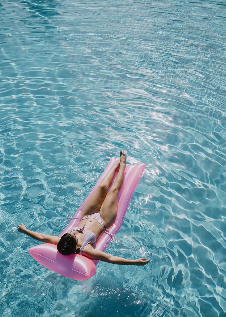 woman-relaxing-mattress-pool